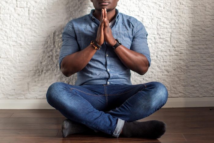 man sitting on the floor, meditating