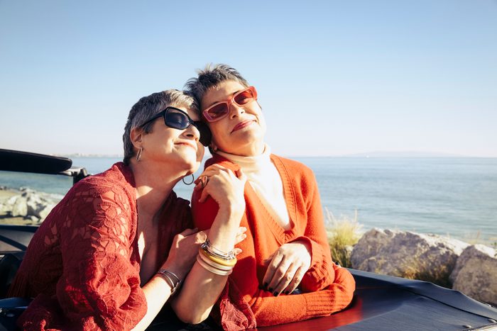 Mature women posing for a photo by the sea