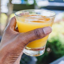 woman holding orange juice